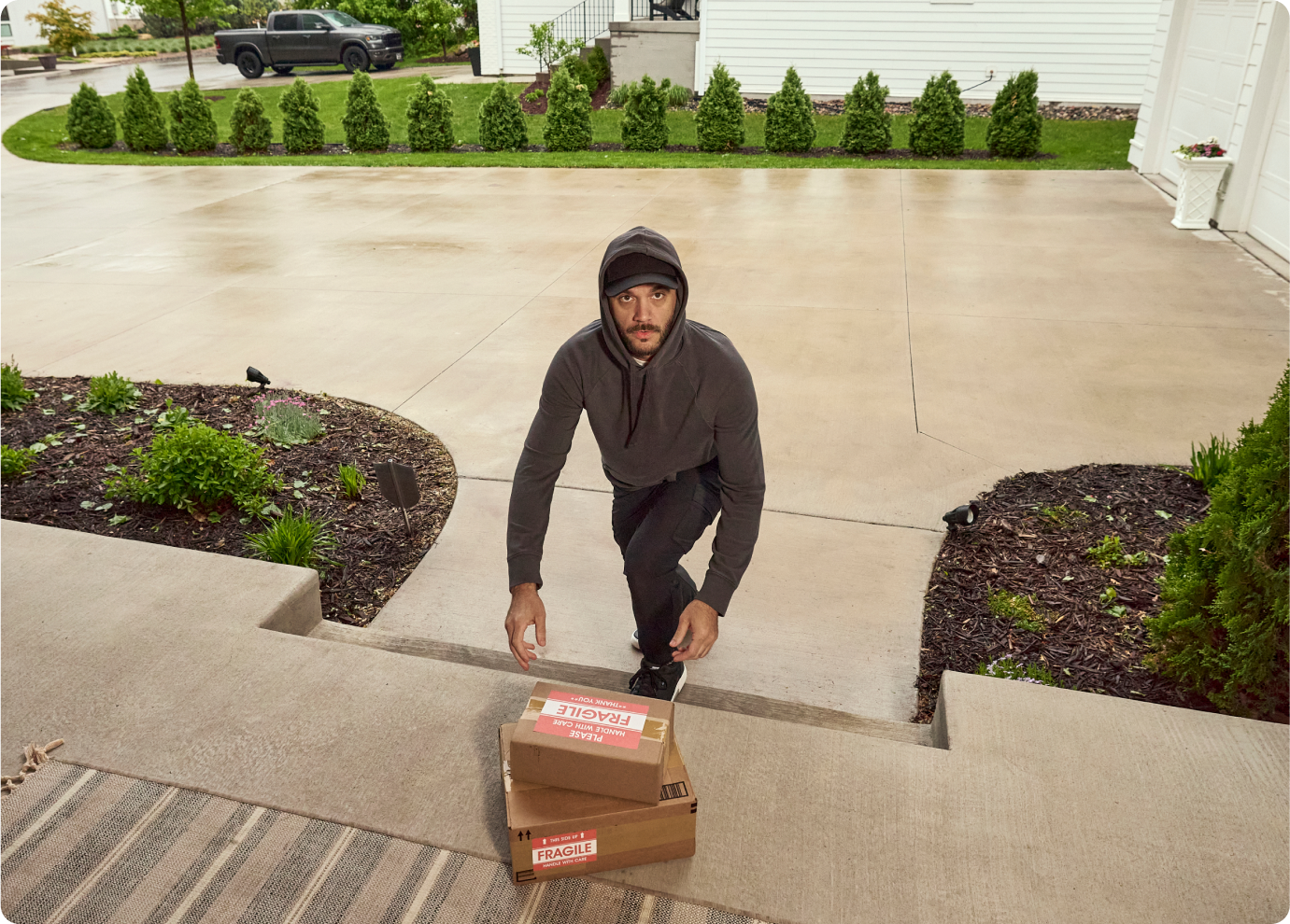 A man trying to steal packages off a front porch