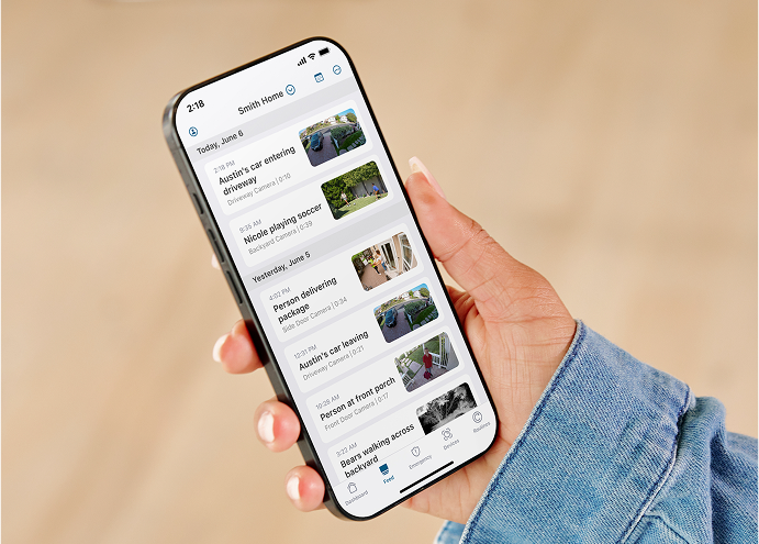 A person holding a phone in hand with the Arlo Secure app on the phone screen