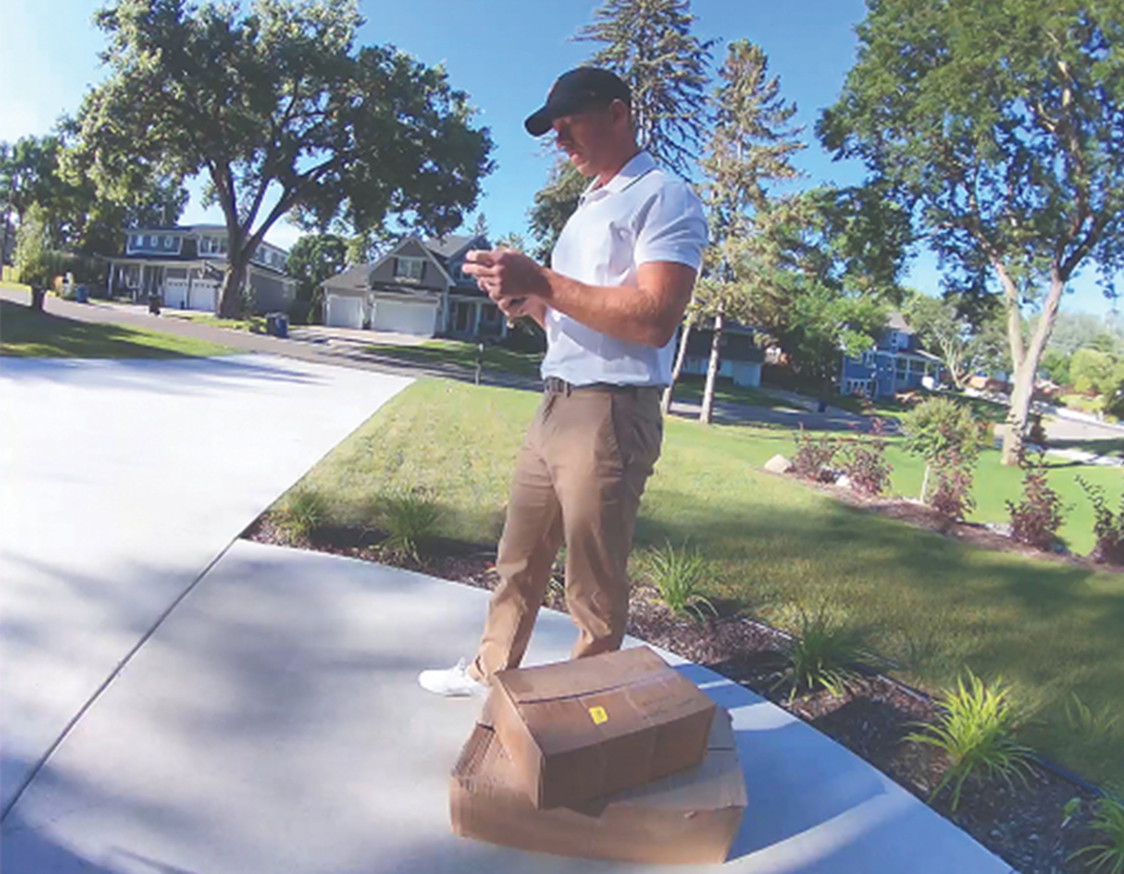 A man delivering packages at the front door