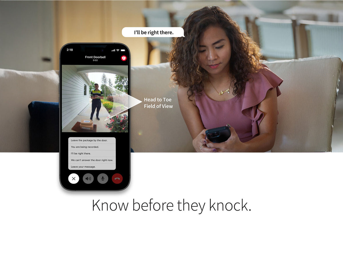 A woman looking at her phone with the Arlo Secure app on her phone screen