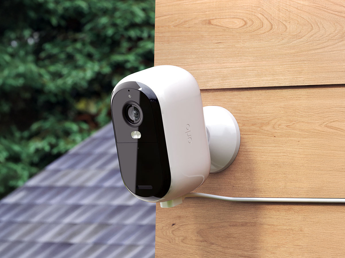 Arlo Essential Security Camera (3rd Gen) attached to a wooden wall outdoors