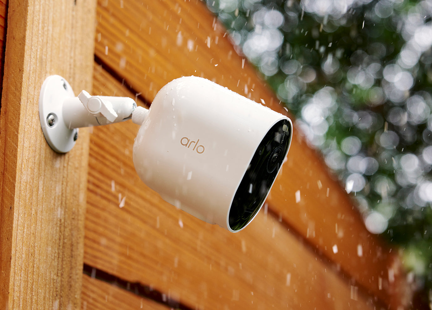 Arlo Pro 6 camera mounted on the side of the house in the rain