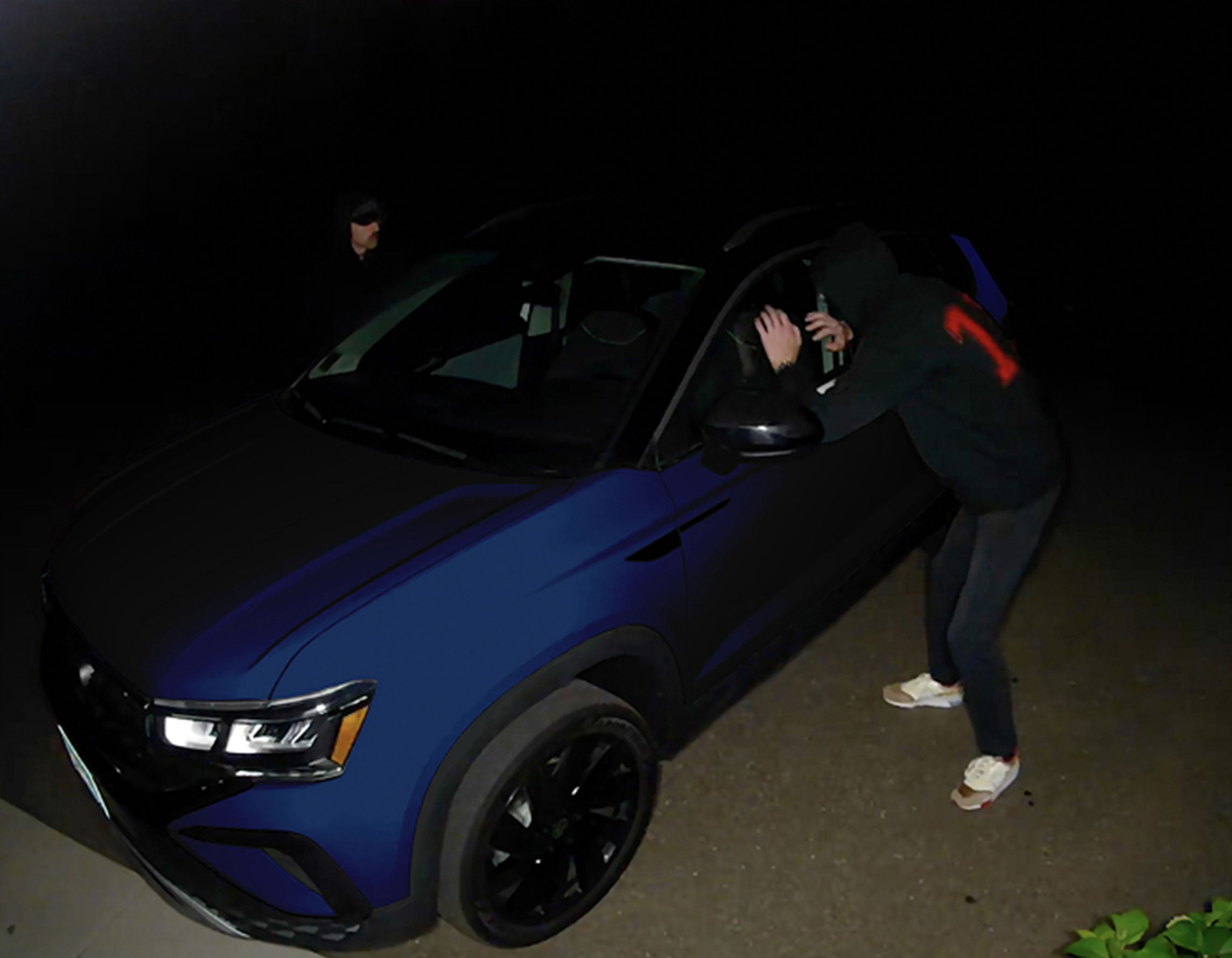 Burglars looking inside of a car