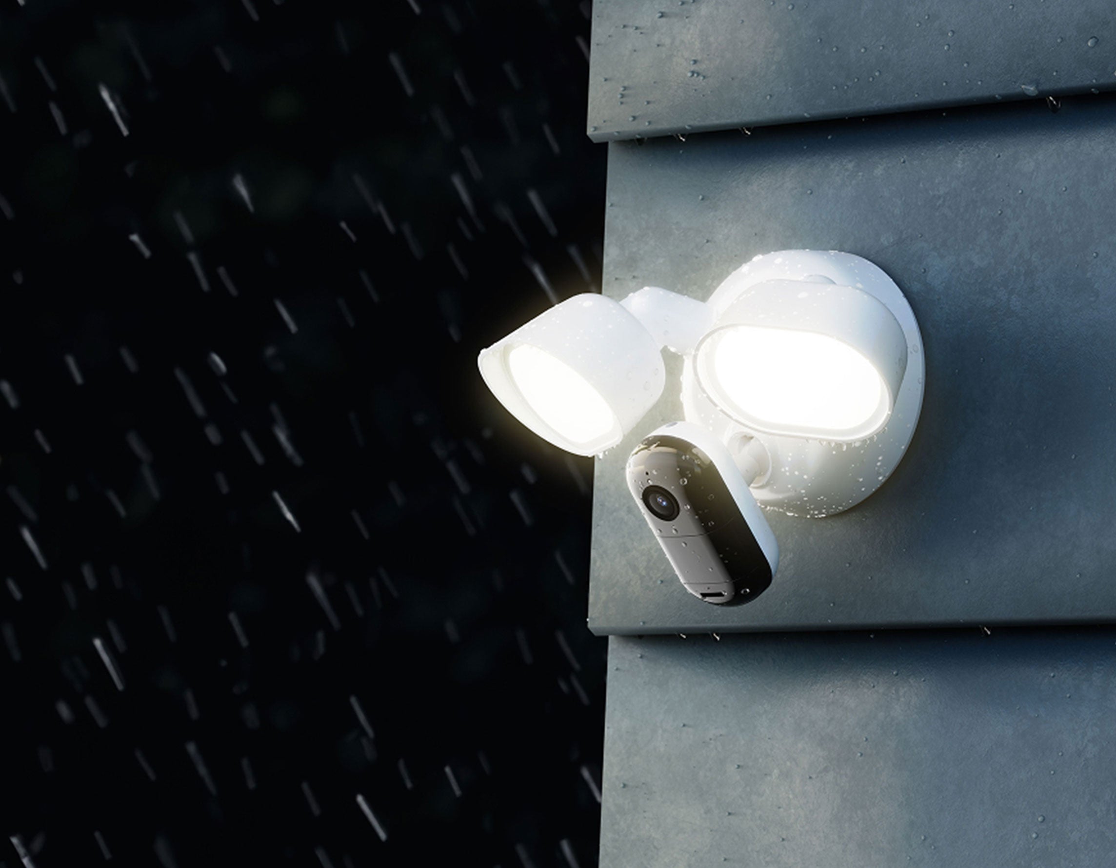 Arlo Wired Floodlight shining a light outside in the rain