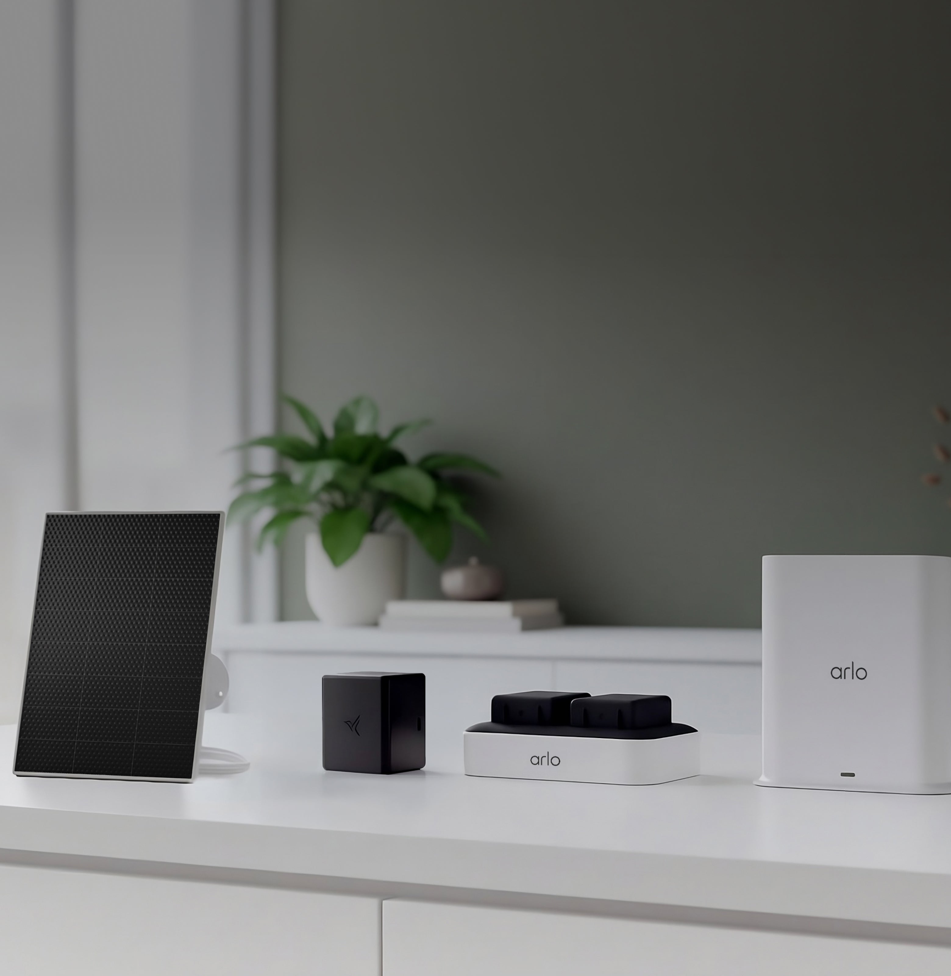 Arlo Solar panel charger, rechargeable battery, dual charging station, SmartHub, on white counter