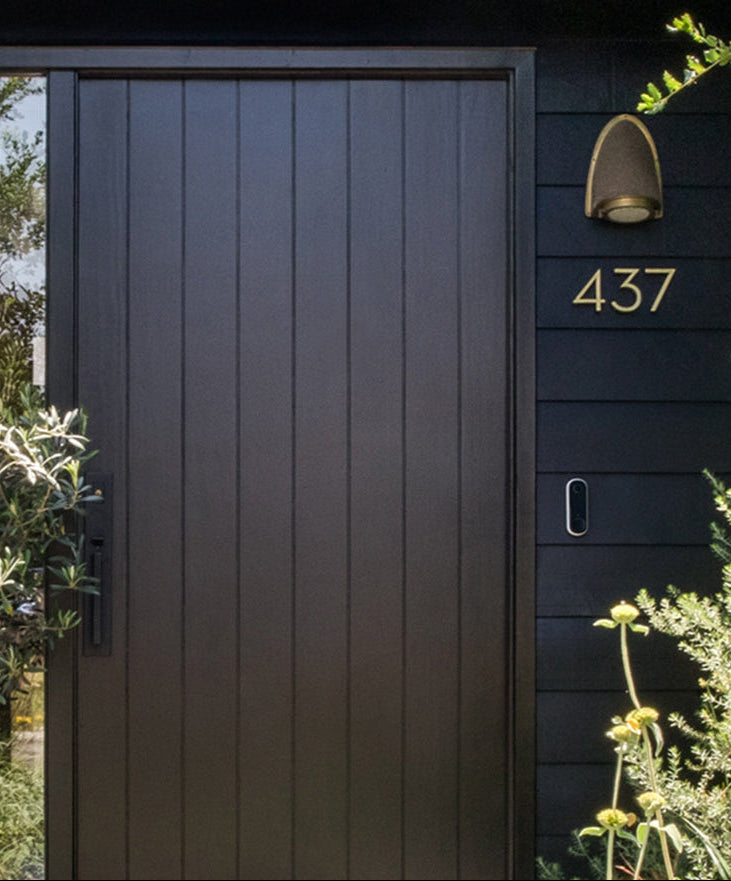 Arlo Video Doorbell mounted next to front door of a house