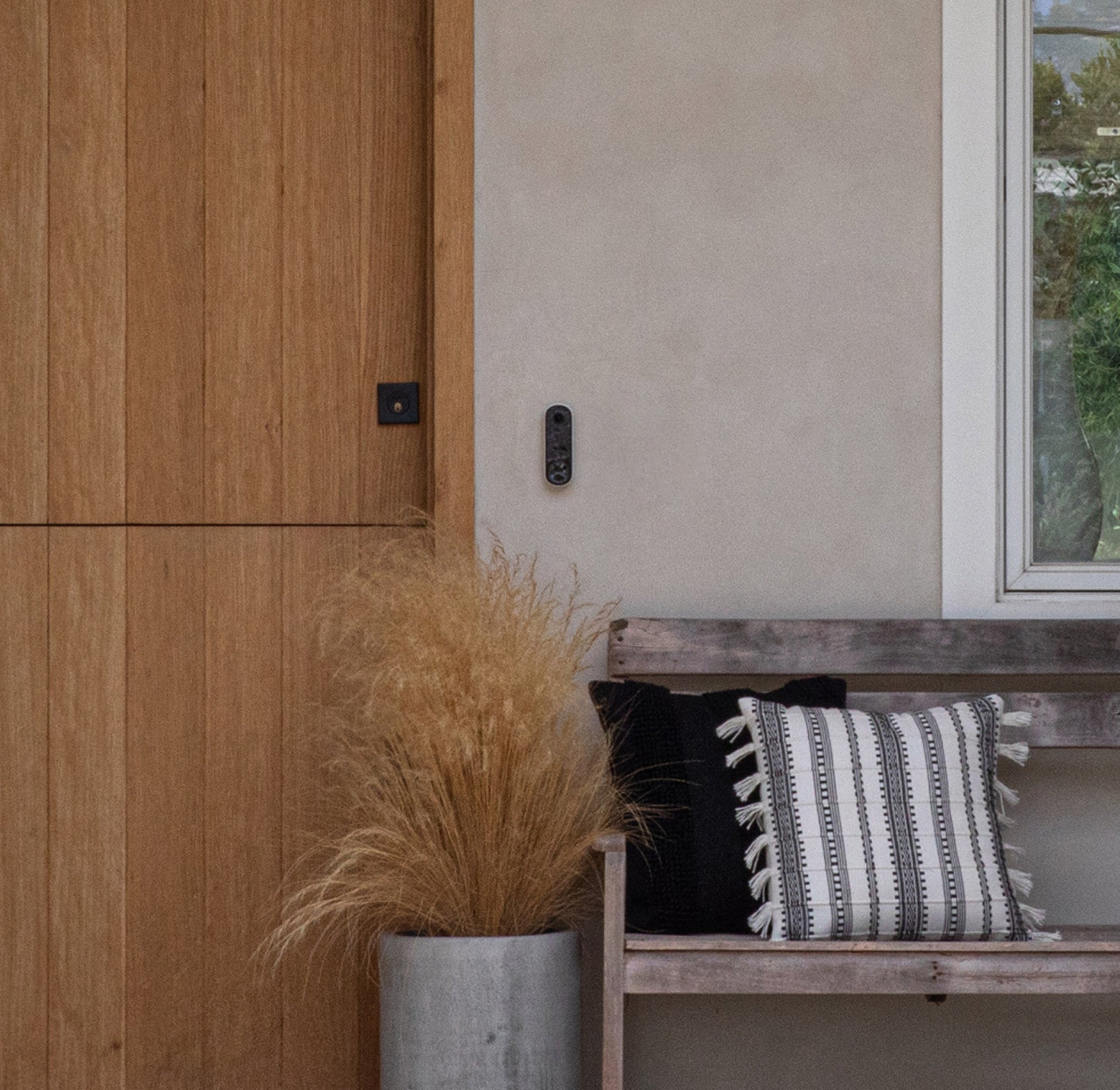 Arlo Video Doorbell mounted on the side of a front door of a house