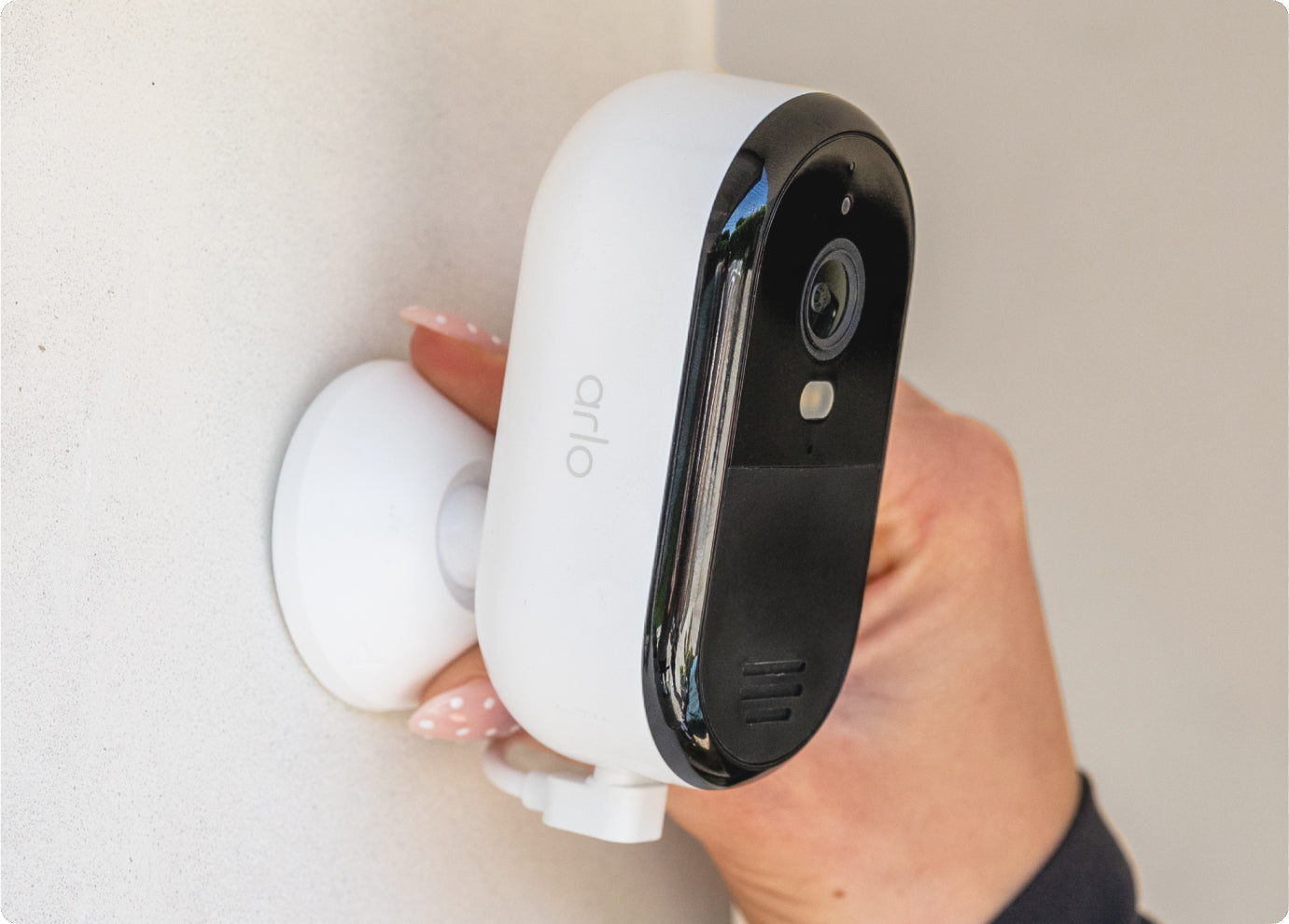 Arlo Essential Plug-in camera mounted on a wall