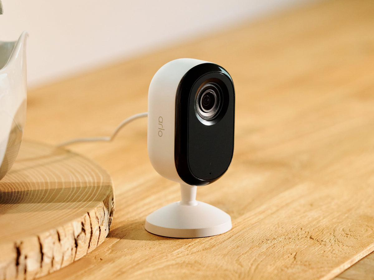 Arlo Essential 3rd Gen Indoor camera on top of a wooden table