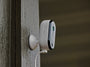 Arlo Essential Plug-in camera mounted on wood