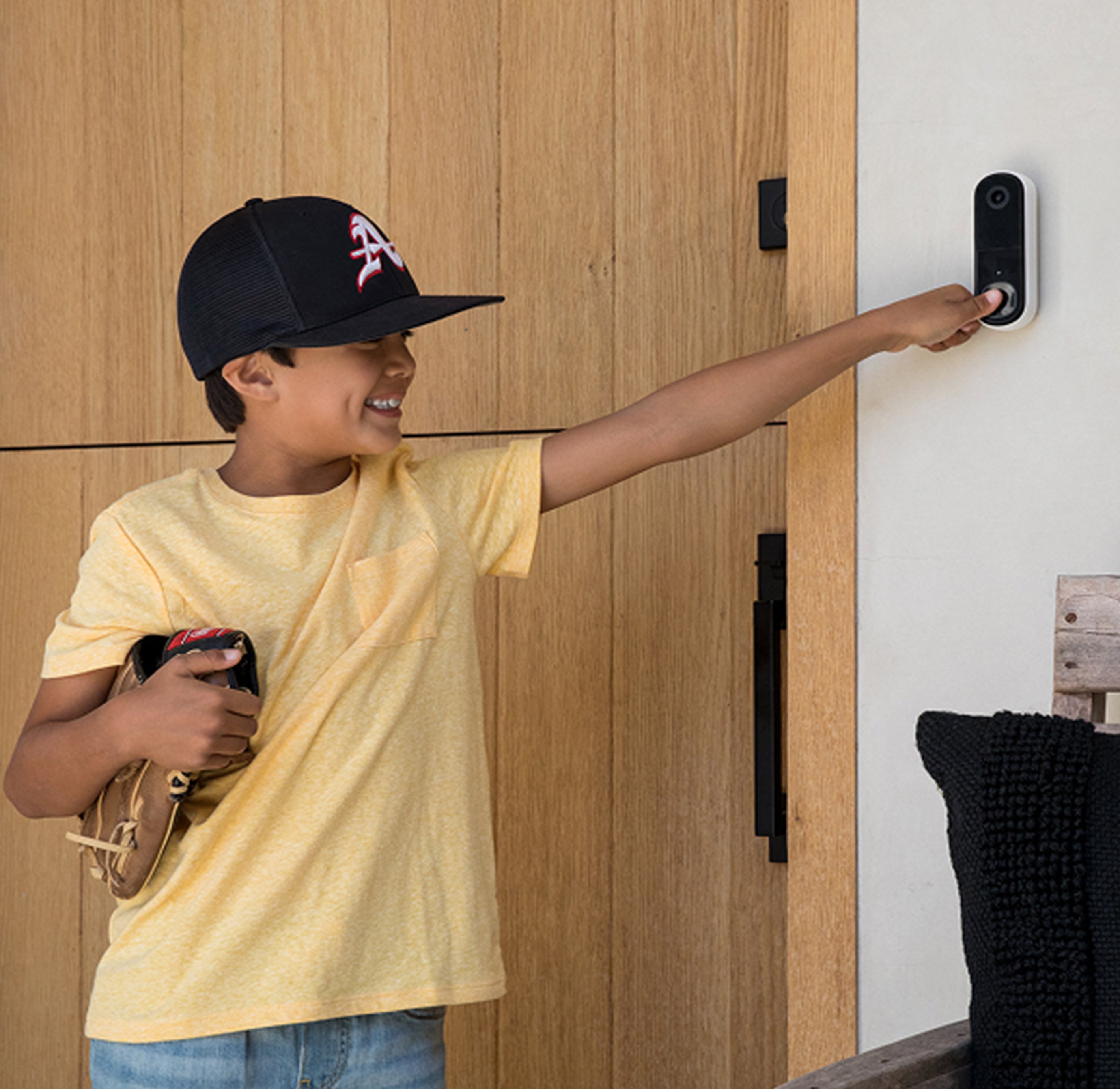 A boy ringing the Arlo Video Doorbell