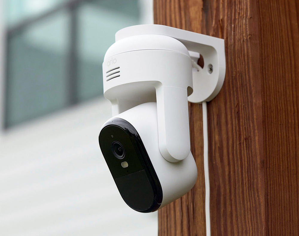 Arlo Essential Pan Tilt camera mounted on a wooden post