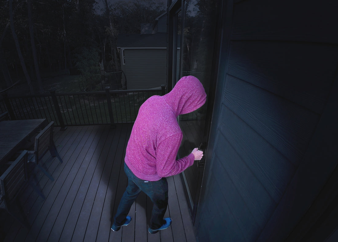 A man trying to break into a home on the back patio of a home at night with the Arlo Secure app notification pop-up animation
