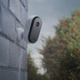 Arlo Essential Plug-in camera mounted on a brick house animation