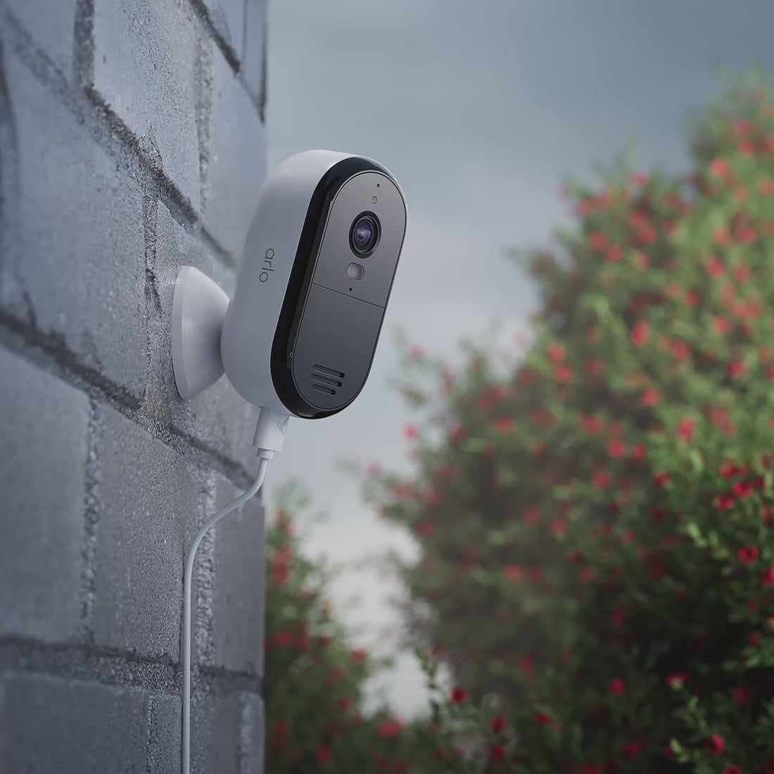 Arlo Essential Plug-in camera mounted on a brick house animation