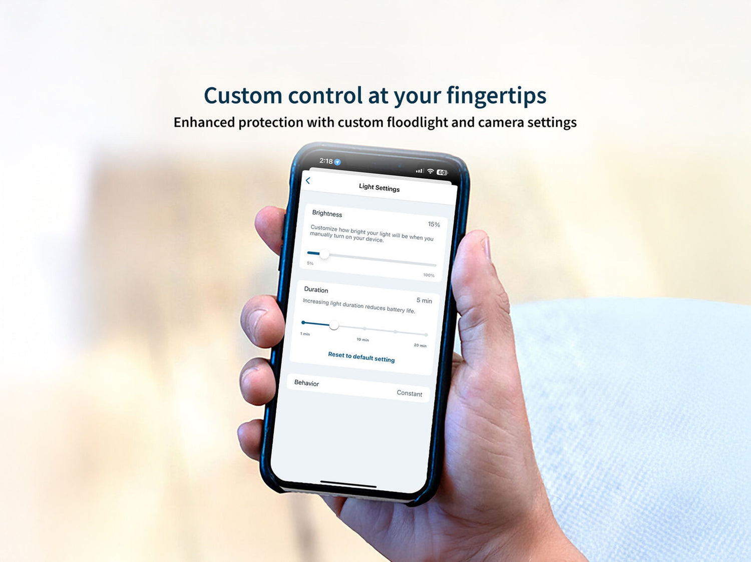 A hand holding a phone with Arlo Secure Light Settings screen