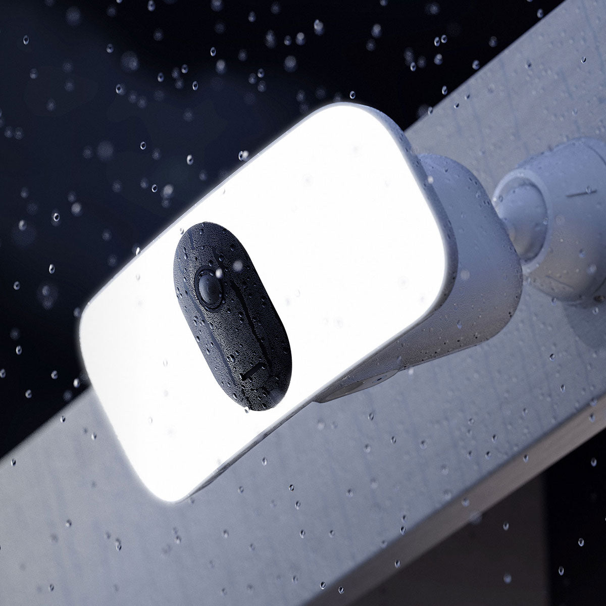 Arlo Wireless Floodlight illuminated at night with rain falling
