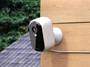 Arlo Essential Security Camera (3rd Gen) attached to a wooden wall outdoors