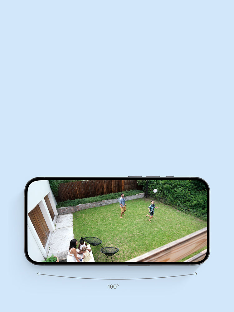 Family playing in the backyard on a phone