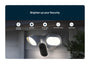 A Arlo Wired floodlight, mounted on a gray house exterior at night. The image includes a dark blue header with the text 'Brighten up your Security.