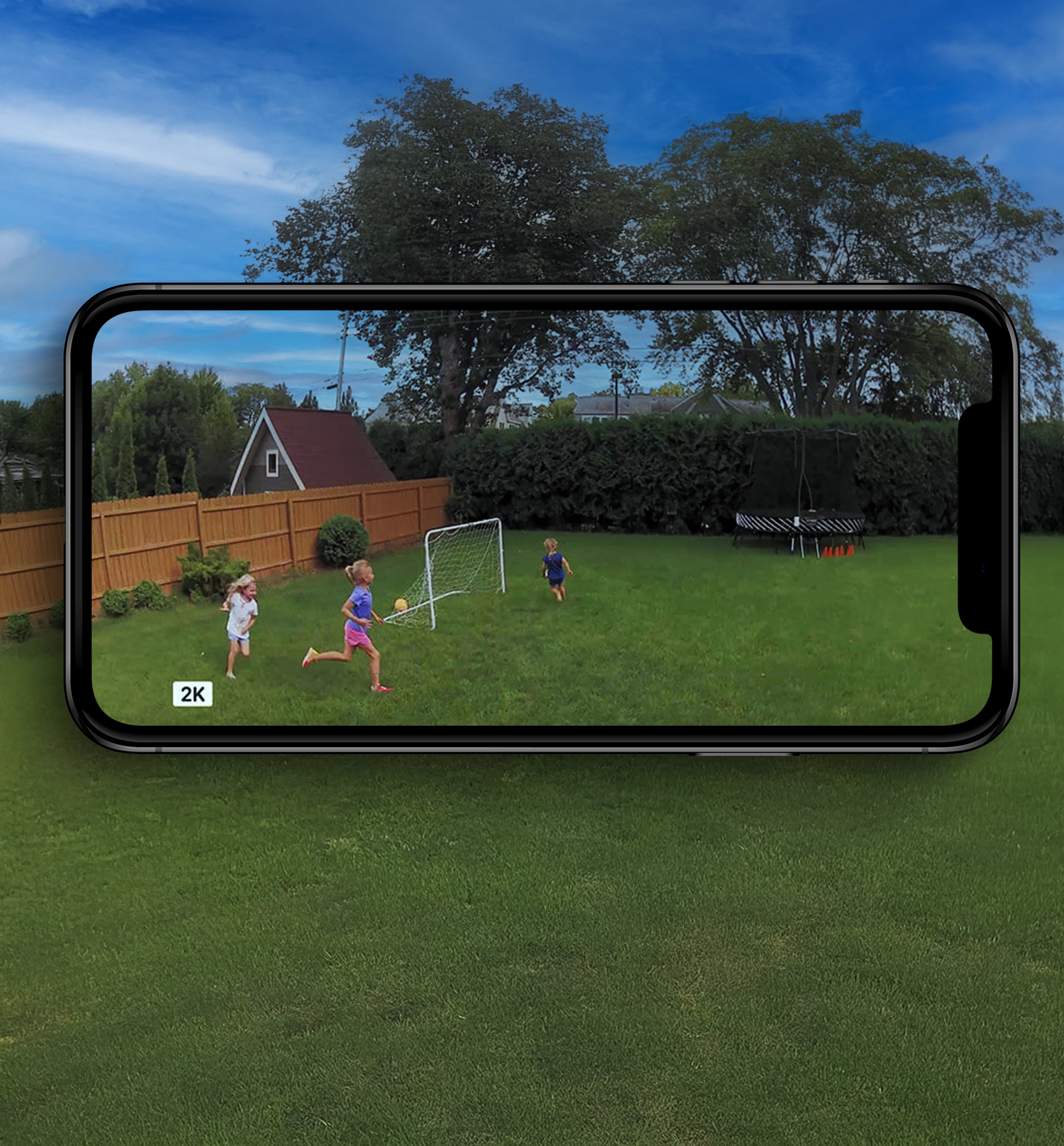 Kids playing in the backyard displaying in 2K on phone